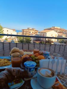 a table with food and drinks on a balcony at B&B Ilary Tropea in Tropea