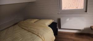 a bed in a small room with a window at G mi cabaña in La Celle-sous-Gouzon +3 photos