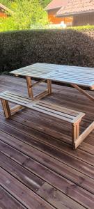 a picnic table sitting on top of a wooden deck at G mi cabaña in La Celle-sous-Gouzon