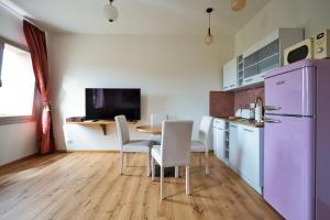 a kitchen with a table and a purple refrigerator at Ap 2 Free Parking Romantic Garden Venice in Mestre