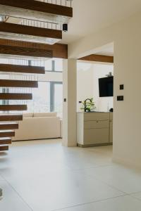 an office lobby with white floors and a staircase at Babiogórska Stodoła in Zawoja