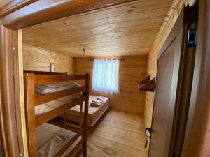 a small room with bunk beds in a cabin at Captain's House in Mollʼ e Shoshit +16 photos