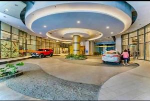 a large building with cars parked in a parking lot at Horizon 101 in Sampong
