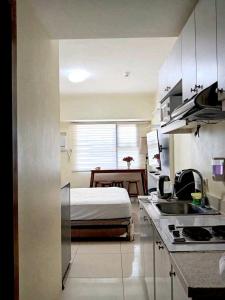 a kitchen with a bed in the middle of a room at Horizon 101 in Sampong