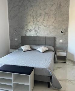 a bedroom with a large bed with two night stands at B&B Ilary Tropea in Tropea