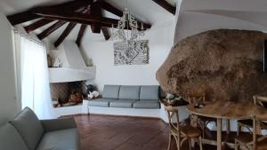 a living room with a couch and a table at Libra Luxury Holidays in Baja Sardinia
