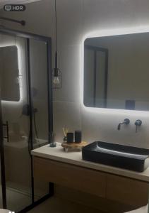 a bathroom with a sink and a mirror at CL Luxury Apartment in Kalamata +38 photos