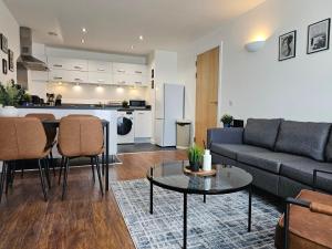 a living room with a couch and a table at TownStay- Modern 2 bedroom apartment with en-suite in Northampton