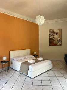 a bedroom with a bed and a chandelier at Le Muse apartment in Caserta