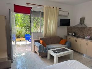 a living room with a couch and a table at Apartments Rudi in Orikum