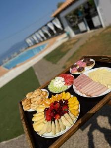 a table with different types of food on plates at Blue escape in Nafplio +39 photos
