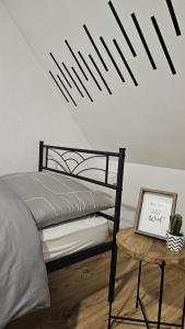 a bedroom with a bed and a table with a picture at Eigene Wohnung und zentrale Lage in Herne