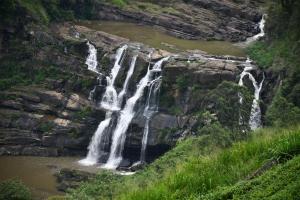 a waterfall on the side of a river at The Mystic in Talawakele