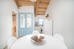a kitchen with a white table with a bowl on it at La Sarda Holiday Homes in Zeddiani