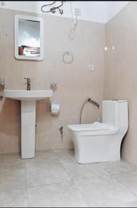 a bathroom with a toilet and a sink at Vivi Cafe B&B in Zanzibar City