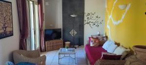 a living room with a couch and a tv at Villa Mary in San Pietro in Bevagna
