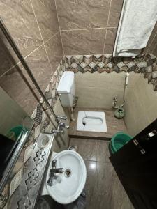 a small bathroom with a sink and a toilet at Sweet Villa Guest House Islamabad in Islamabad