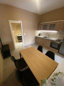 a kitchen with a wooden table and chairs at Spitaki Luxury Home in Agia Triada +5 photos