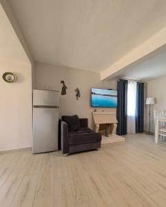 a living room with a couch and a refrigerator at Luxury House California 1 in Himare +20 photos