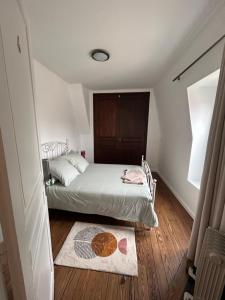 a small bedroom with a bed and a rug at Maison proche Disneyland paris in Boissy-Saint-Léger +13 photos