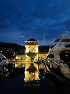 a marina with boats in the water at night at Palada House with a Private Pool in Marina
