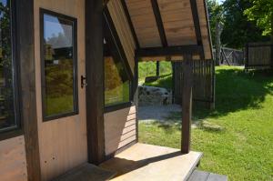 an open door of a house with a porch at Glamping Gradiško in Nova Vas +8 photos