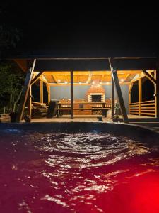 a view of a pool at night at Julien House in Prisaca Dornei