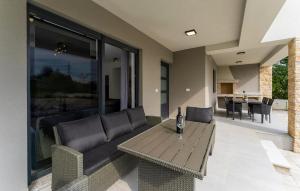 a living room with a couch and a table at Beautiful Home In Labin in Labin