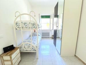 une chambre avec deux lits superposés et un miroir dans l'établissement Marea, vicino mare con parcheggio by Alfareal, à Castiglione della Pescaia