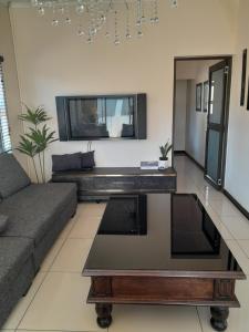 a living room with a couch and a coffee table at The Ridge BnB in Manzini