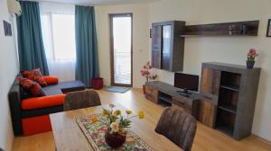 a living room with a couch and a table at Byala Vista Beach Apartments D - Бяла Виста Бийч Апартментс Д in Byala