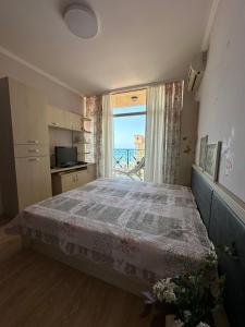 a bedroom with a bed and a window with a view at 2 bedroom apartment komplex Andalusia Elenite with terrasa and sea in Sveti Vlas +18 photos