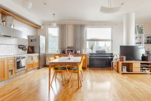 a kitchen with a table and chairs in a room at 100 square meter 4-room central smart apt in Tallinn