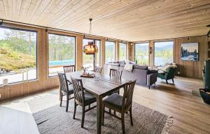 a living room with a table and chairs and a couch at 4 Bedroom Nice Home In Vinje in Trovatn