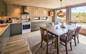 a large kitchen with a wooden table and chairs at 4 Bedroom Nice Home In Vinje in Trovatn