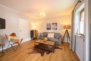 a living room with a couch and a table at Das Bergquartier - Ferienwohnung Zugspitze in Oberau