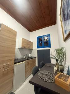 a kitchen with a table and a kitchen with a stove at Occasus Room in Halki +18 photos