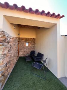 a patio with two chairs and a stone wall at MirakostaCB in Castelo Branco +44 photos