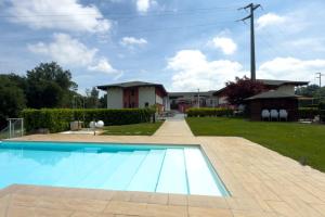 a swimming pool in front of a house at Trilogy San Giovanni in Torre Canavese