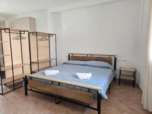 ラ・マッダレーナにあるSummer home96のベッドルーム1室(ベッド1台、白いタオル2枚付)
