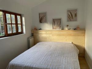 a bedroom with a white bed in a room at Chalet entre océan et foret au calme in Ondres