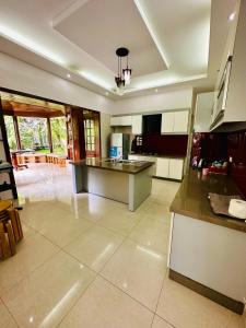 a large kitchen with a counter top in a room at Jakaranda Villa Dalat in Da Lat +30 photos