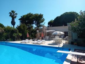 a pool with a view of the house and the villa at Villa Maria in Maruggio