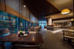 a restaurant with tables and chairs and a cafeteria at Atour Hotel Chunxi Road Chengdu in Chengdu