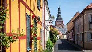 an empty street in a town with buildings and a tower at Villa Vinja in Ystad