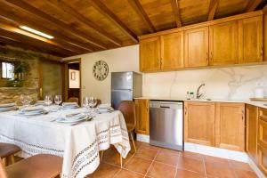 una cucina con tavolo e bicchieri da vino di A Casa do Carpinteiro 