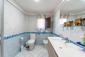 a bathroom with a toilet and a sink at Casa Vacanze Catania - Giarre Etna D'Amore in Giarre +11 photos