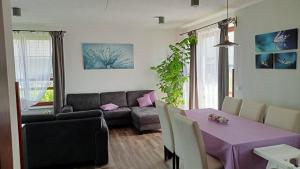 a living room with a purple table and a couch at Bíbic Apartman D in Kápolnásnyék