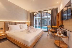Postel nebo postele na pokoji v ubytování Suites5 Hotel