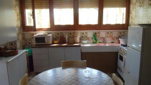a small kitchen with a table and a microwave at Villa Maria in Maruggio